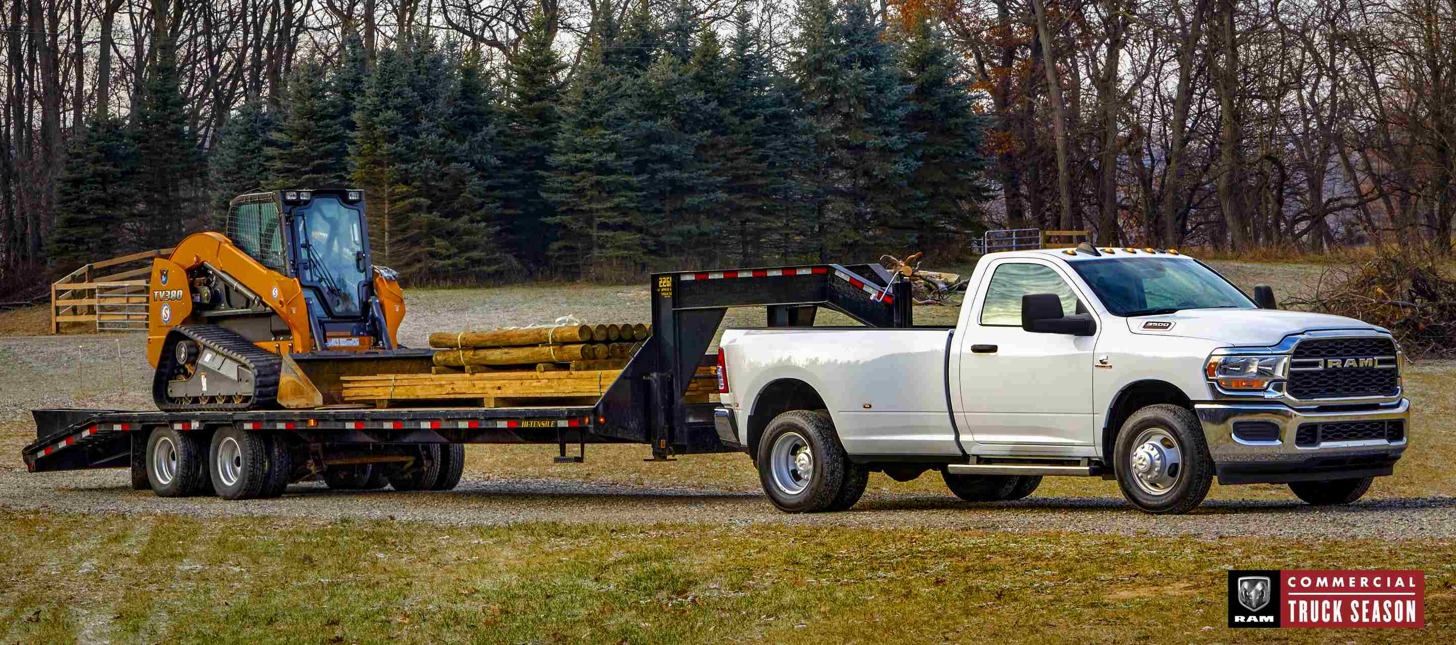 A white 2024 Ram 3500 Tradesman 4x4 Regular Cab towing a fifth wheel flatbed trailer loaded with an excavator and lumber. Ram Commercial Truck Season.