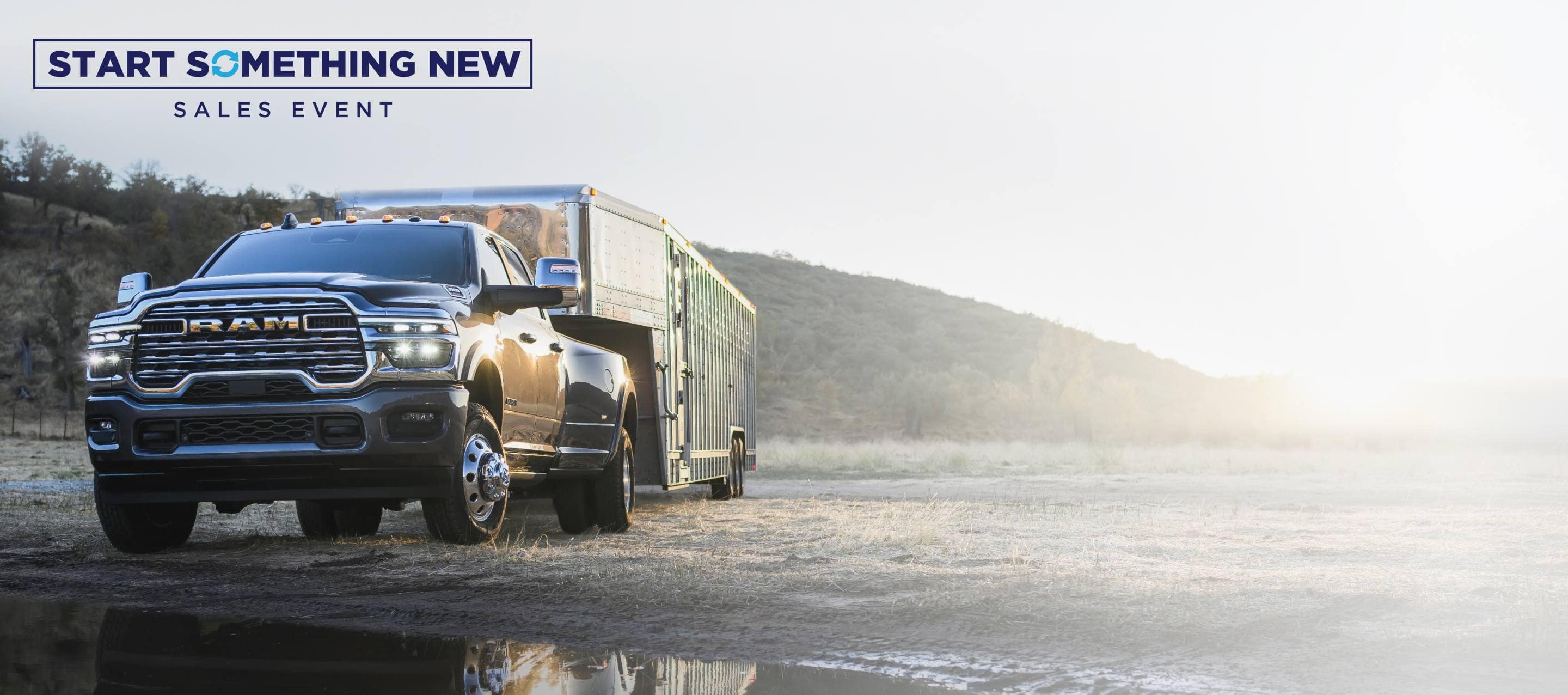 A red 2025 Ram 3500 Laramie 4x4 Crew Cab towing an enclosed box. Start Something New Event.