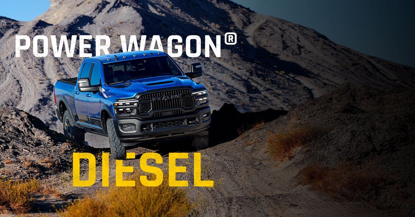 A blue 2026 Ram 2500 Power Wagon climbing a rugged trail off-road. Power Wagon. Diesel.