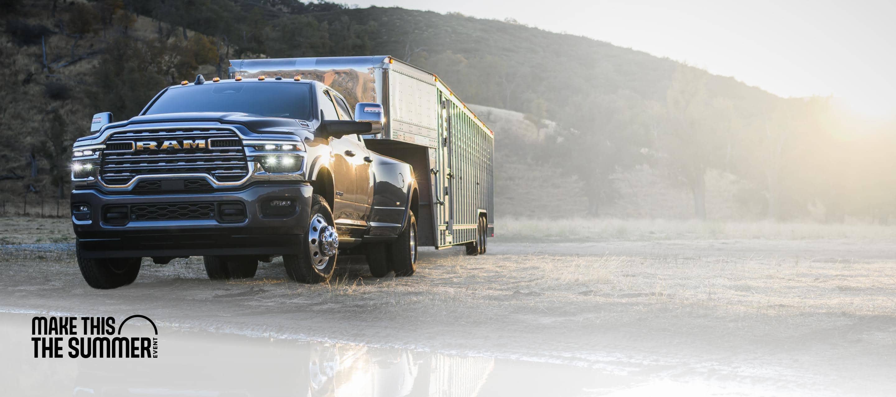 A black 2026 Ram 3500 Limited Longhorn 4x4 Crew Cab heavy-duty pickup towing a large livestock trailer. Make This The Summer Event.