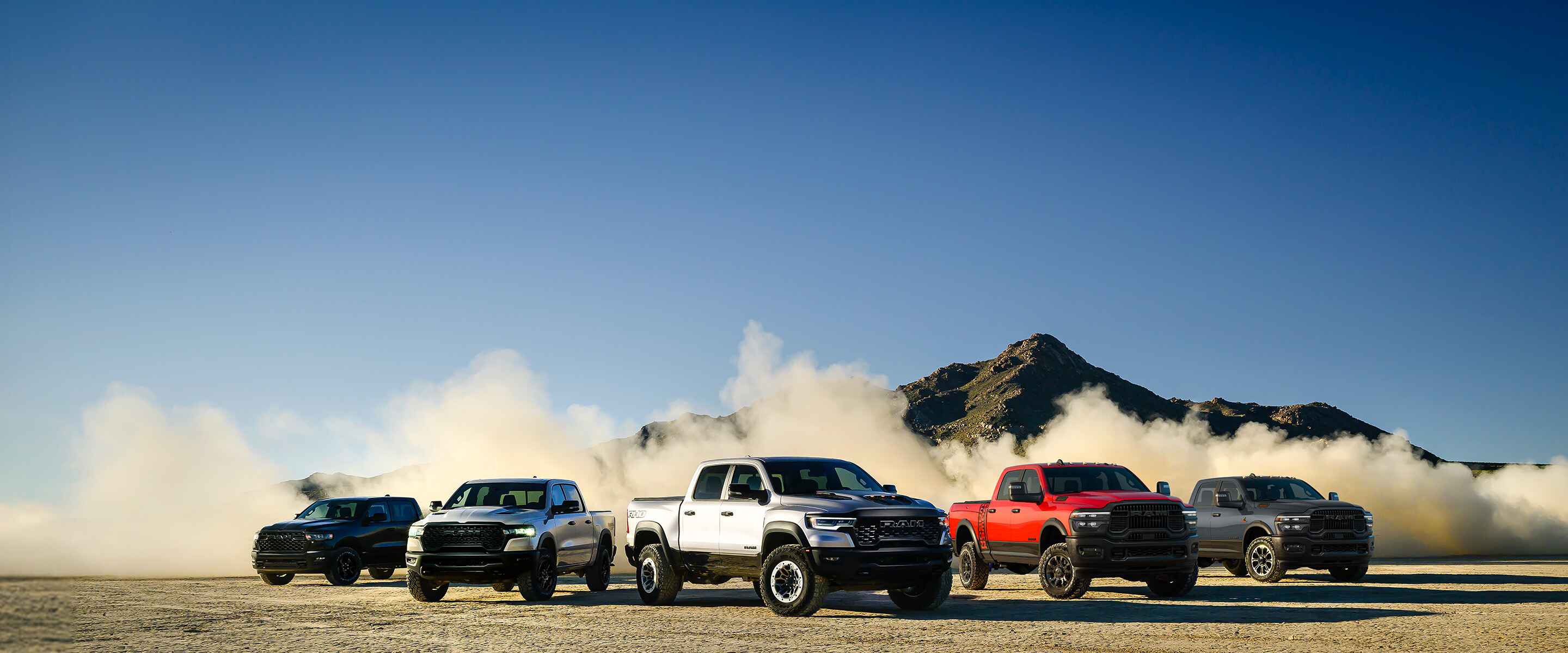 Pack shot of 2025 Ram trucks in a desert setting.