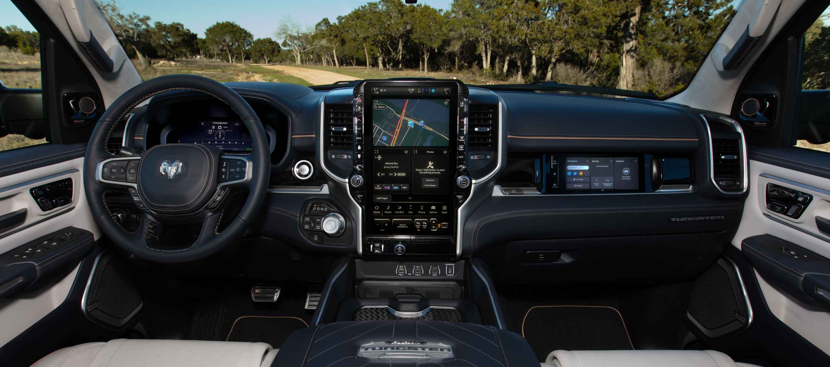 The steering wheel, Driver Information Digital Cluster, Uconnect touchscreen and front Passenger Interactive Touchscreen Display in the 2025 Ram 1500 Tungsten.