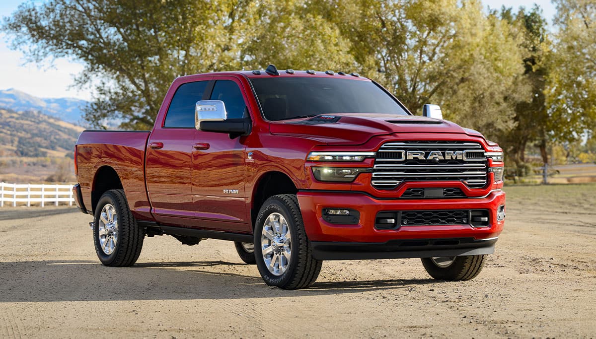 Display A red 2025 Ram 2500 Laramie 4x4 Crew Cab with mountains in the background.