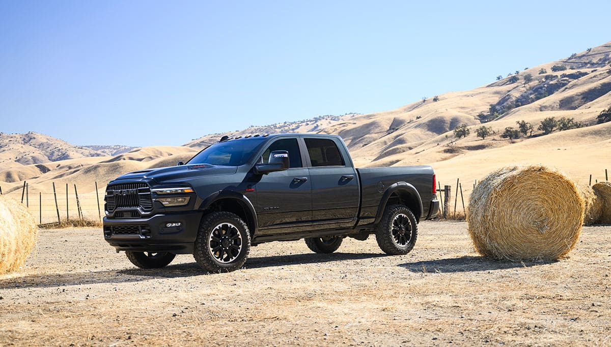 Display A gray 2025 Ram 2500 Rebel 4x4 Crew Cab parked at a ranch.