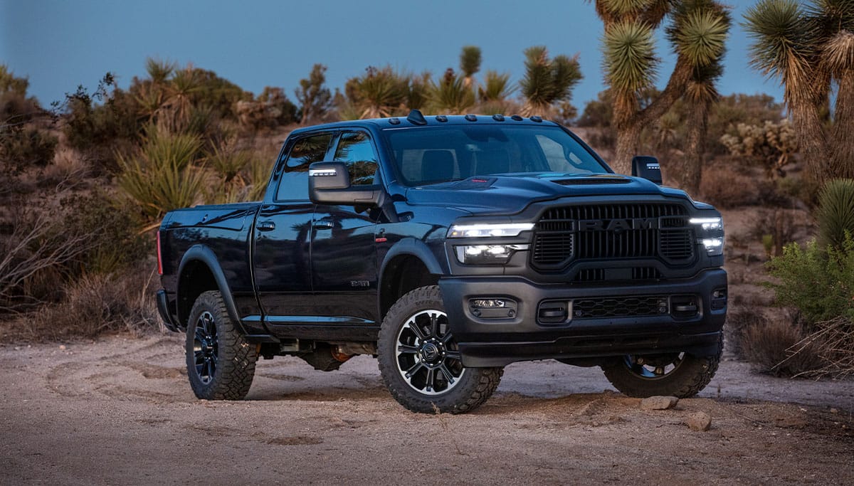 Display A black 2025 Ram 2500 Rebel 4x4 Crew Cab parked in the desert.