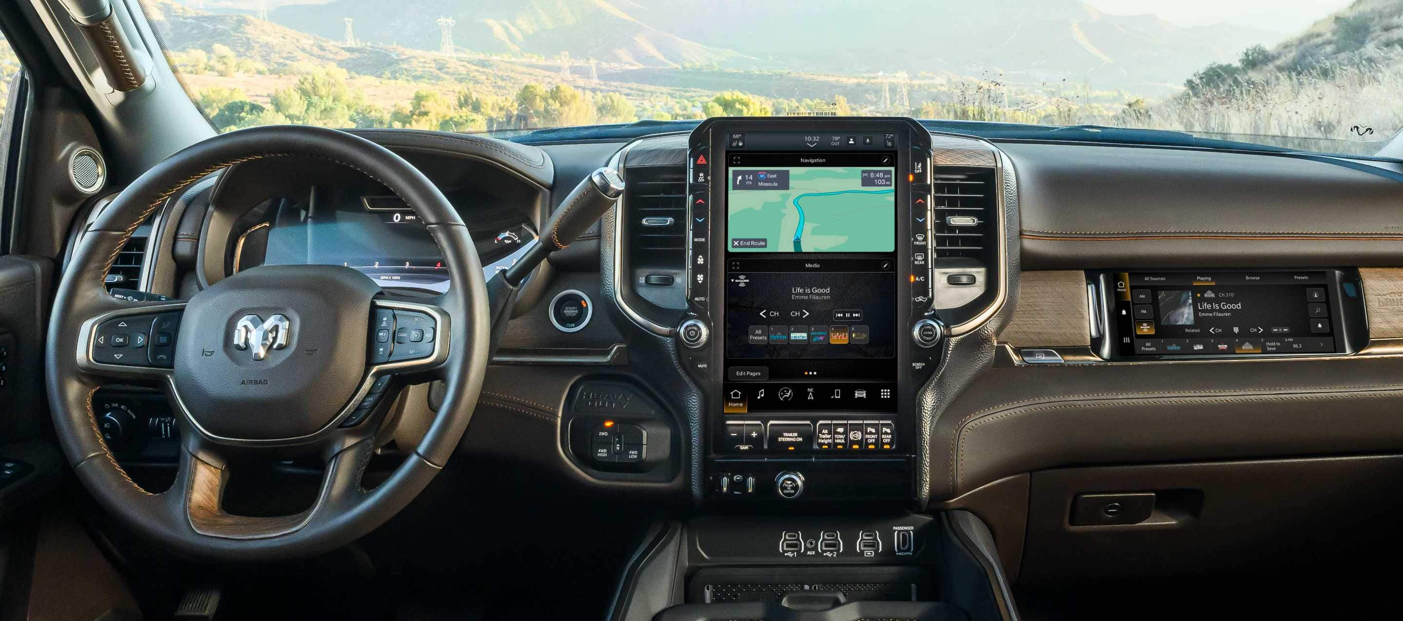 The interior of a 2025 Ram 3500 Limited Longhorn from the driver's perspective, demonstrating through the windshield that the vehicle is in the mountains.