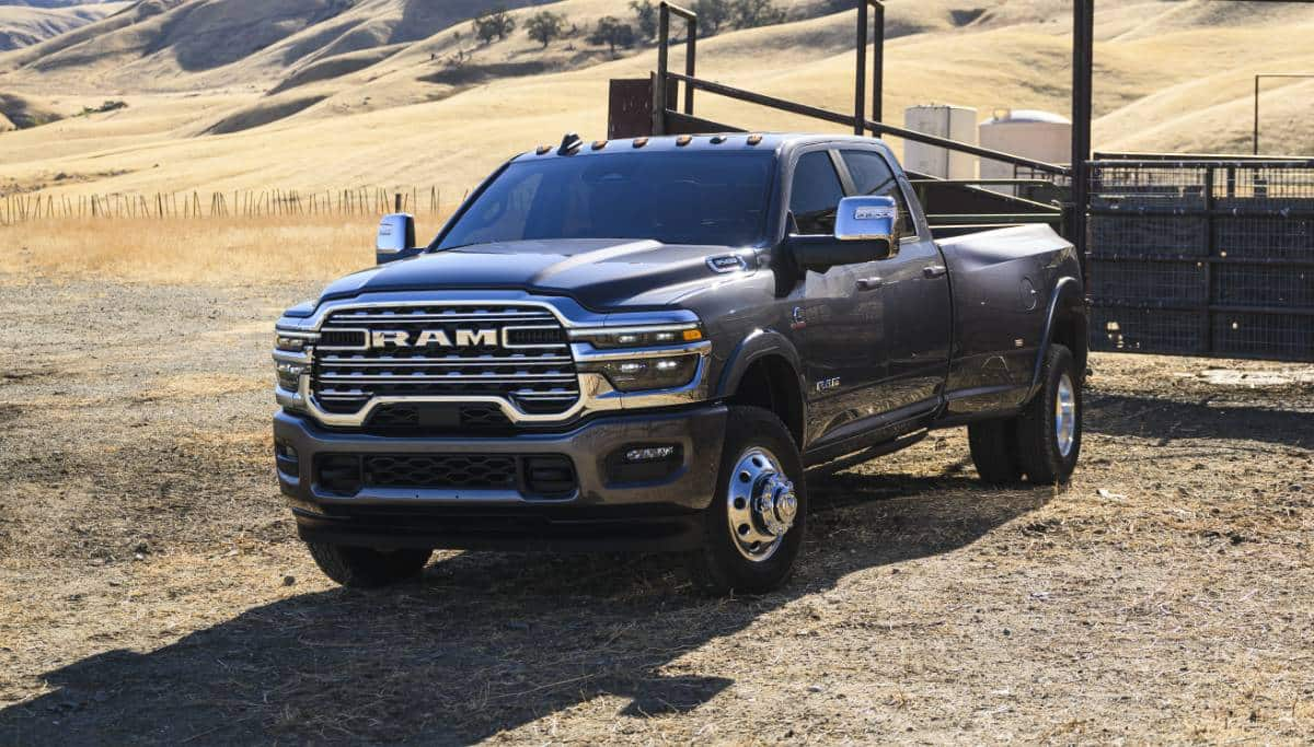 Display A gray Ram 3500 Limited Longhorn Crew Cab parked at a cattle ranch in the desert.