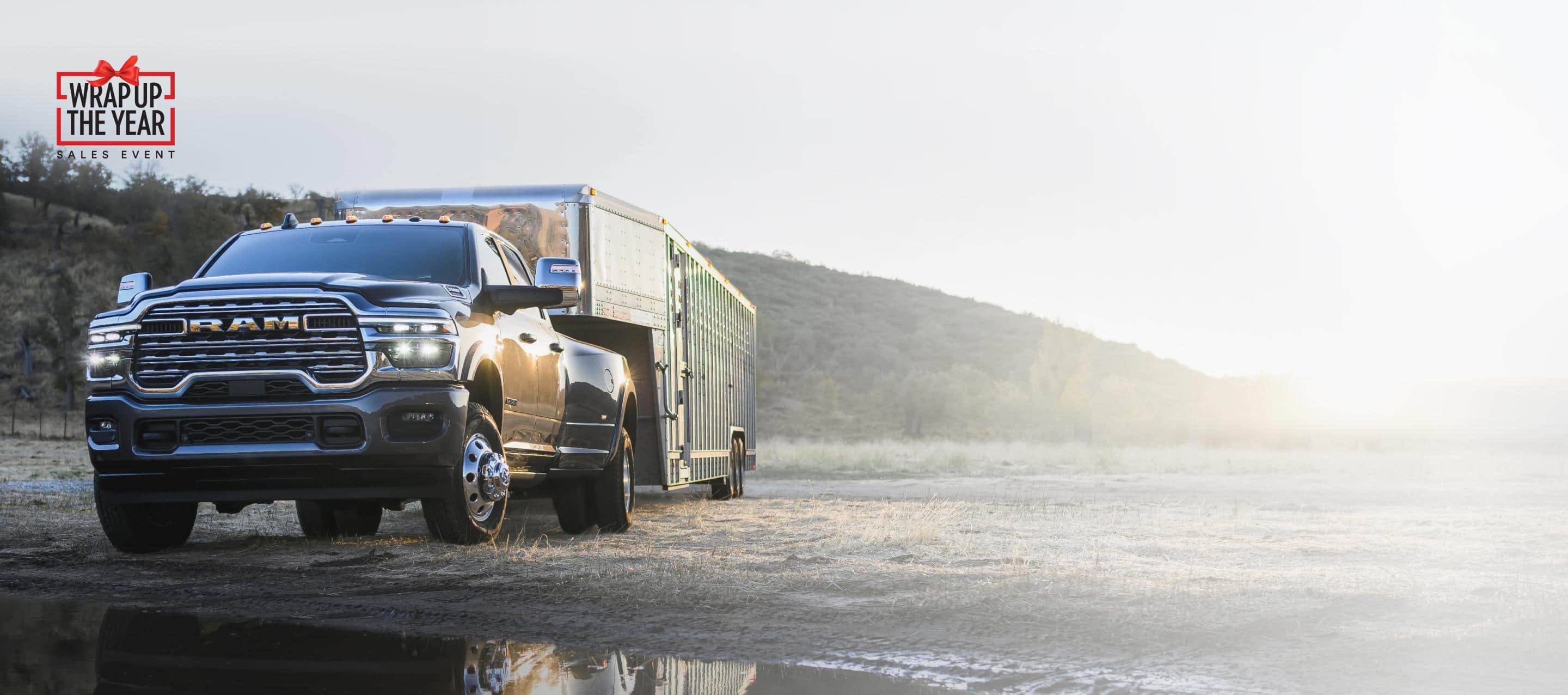 A red 2025 Ram 3500 Laramie 4x4 Crew Cab towing an enclosed box. Wrap Up The Year Sales Event.