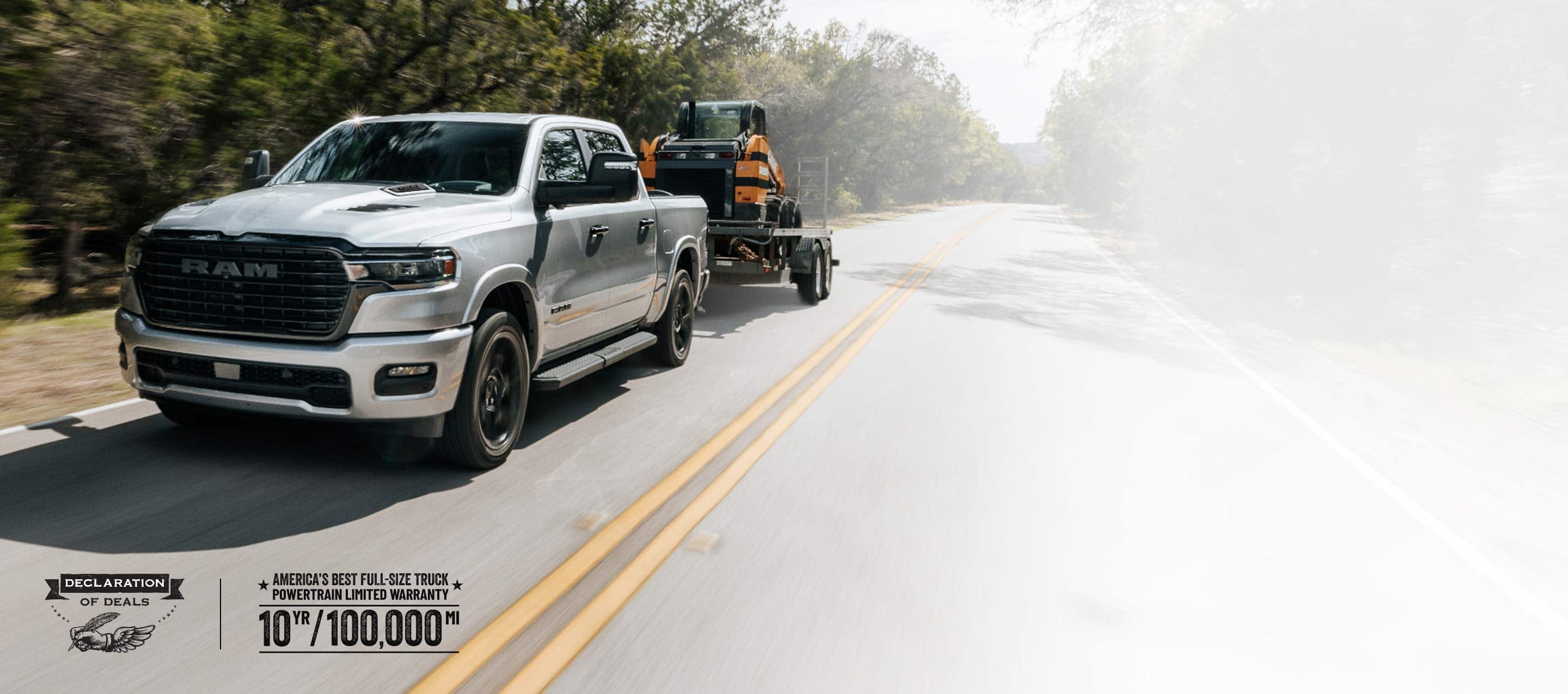 A silver 2026 Ram 1500 Laramie 4x4 Crew Cab traveling down a highway, towing a skidsteer loader. Limited Warranty—10 Years/100,000 Miles. Declaration of deals Sales Event.