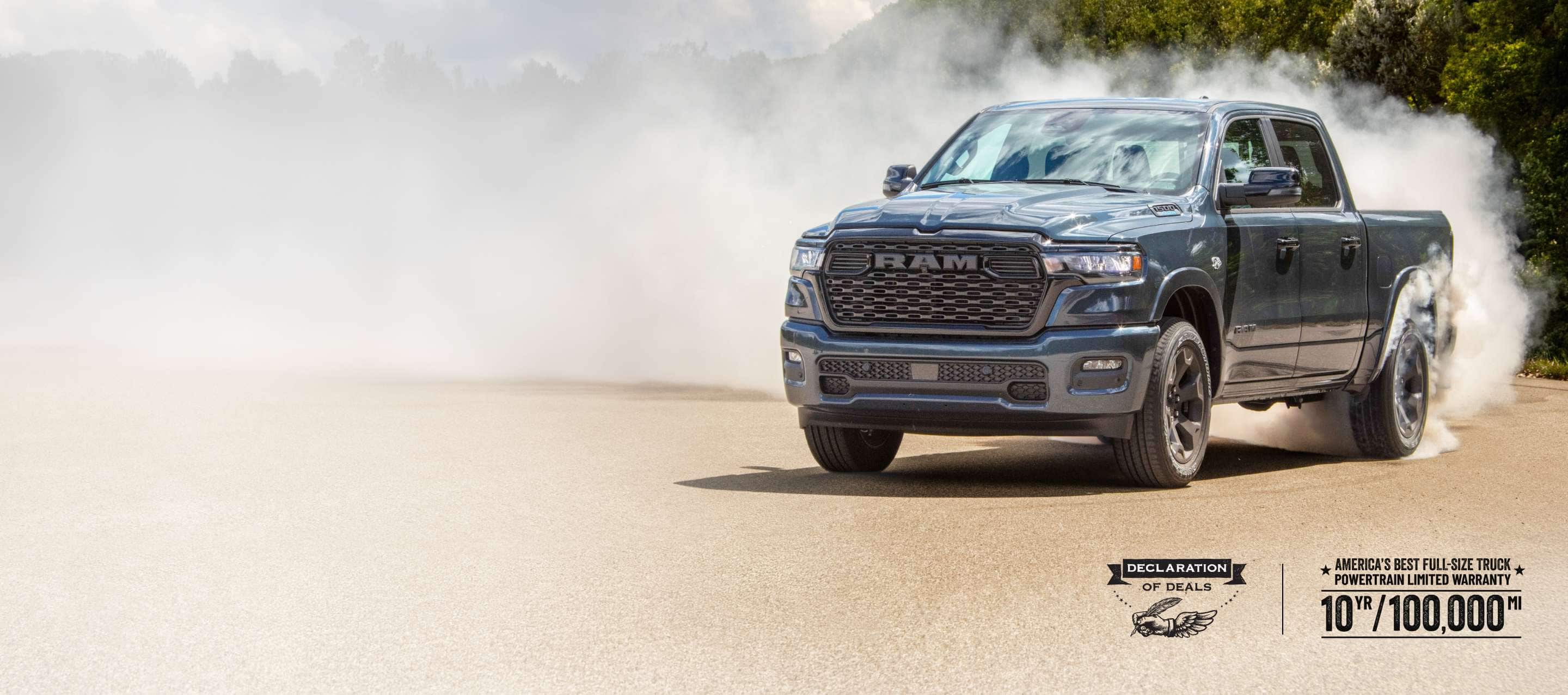 A passenger-side front angle of a blue 2026 Ram 1500 Big Horn 4x4 Crew Cab, with a trail of white smoke billowing from its rear tires. America's Best Full-Size Truck Powertrain Limited Warranty—10 Years/100,000 Miles. Declaration of deals Sales Event.