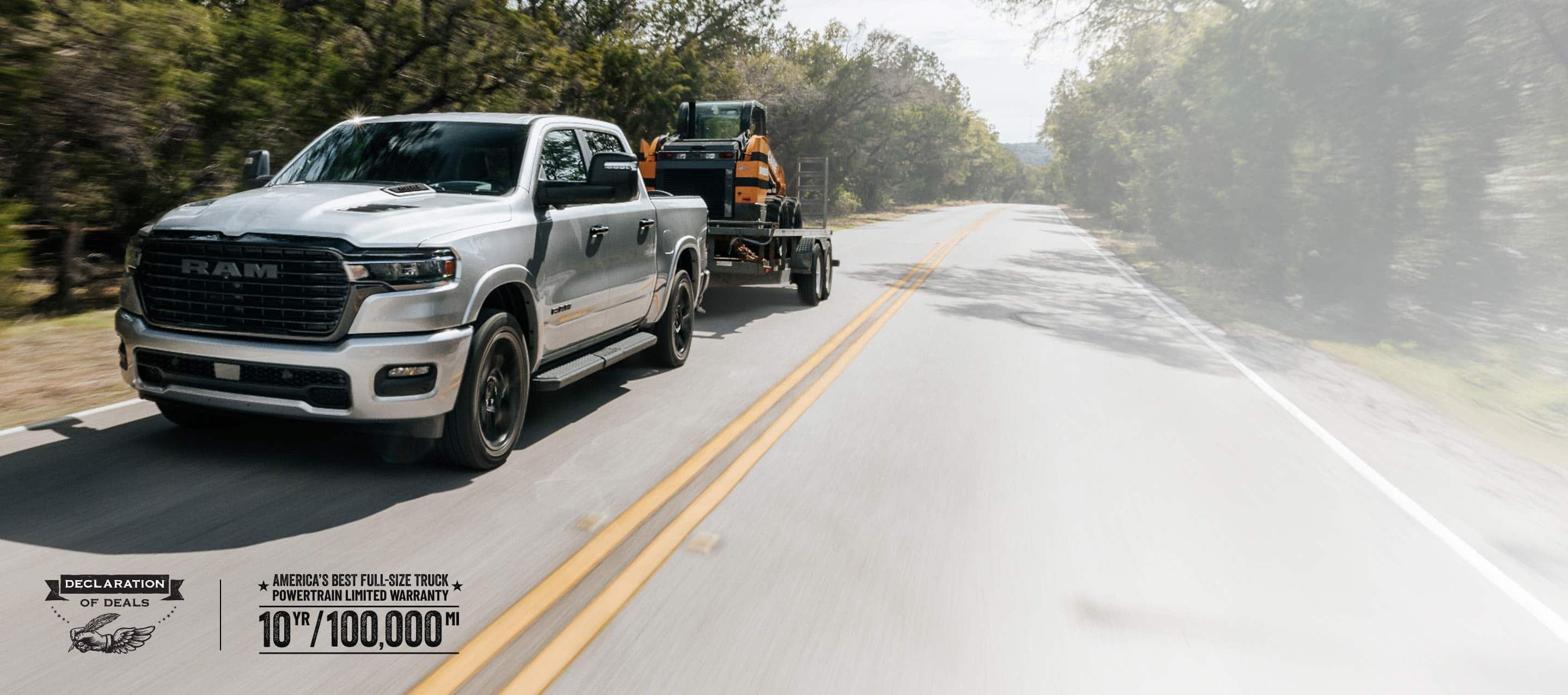 A silver 2026 Ram 1500 Laramie 4x4 Crew Cab traveling down a highway, towing a skidsteer loader. Limited Warranty—10 Years/100,000 Miles. Declaration of deals Sales Event.